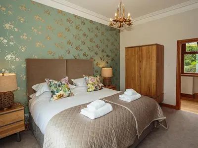 a bedroom with a bed with towels on it at Kringlands in Stranraer