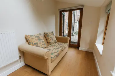 a living room with a chair and a window at ELM HOUSE COTTAGE - 2 Bed Cottage in High Hesket on the edge of the Lake District, Cumbria in High Hesket