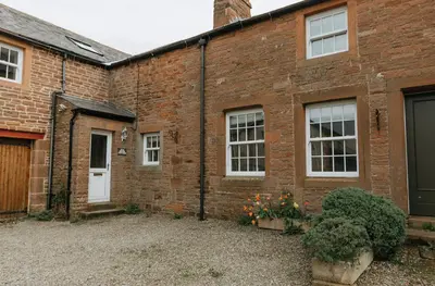an old brick house with a courtyard in front of it at ELM HOUSE COTTAGE - 2 Bed Cottage in High Hesket on the edge of the Lake District, Cumbria in High Hesket