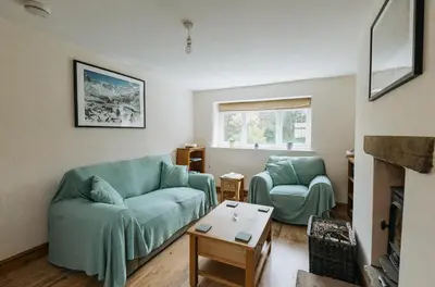 a living room with two blue couches and a table at ELM HOUSE COTTAGE - 2 Bed Cottage in High Hesket on the edge of the Lake District, Cumbria in High Hesket