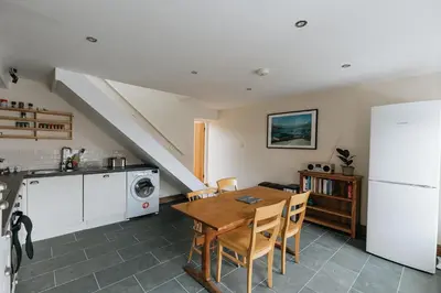 a kitchen and dining room with a table and a refrigerator at ELM HOUSE COTTAGE - 2 Bed Cottage in High Hesket on the edge of the Lake District, Cumbria in High Hesket
