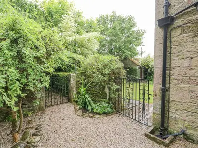 an entrance to a garden with a wrought iron gate at The Lodge in Penrith
