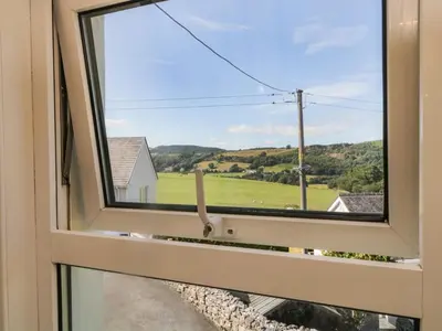 a window with a view of a field at Fellside Cottage in Cockermouth