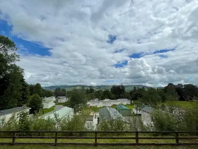 a view of a small town under a cloudy sky at Beautiful 3BR Holiday Home in Stunning Location - Pass the Keys in Moffat