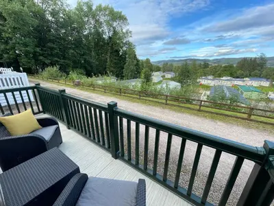 a balcony with chairs and a view of a field at Beautiful 3BR Holiday Home in Stunning Location - Pass the Keys in Moffat