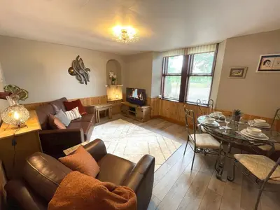 a living room with a couch and a table at Beautiful Apartment - Outstanding Central Location - Pass the Keys in Dumfries