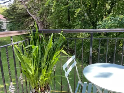 a table and a chair and a plant on a balcony at Turnberry Apartment - Ailsa Gem in Turnberry