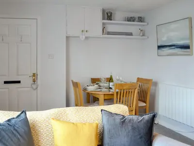 a living room with a table and a couch at Number 7 in Gatehouse of Fleet