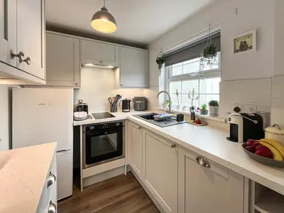 a kitchen with white cabinets and a counter top at Number 7 in Gatehouse of Fleet