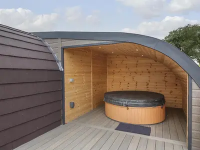 an outdoor sauna with a large tire in the middle at Laird Lodge 4 in Lockerbie