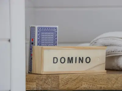 a wooden box with the word domino sitting on a table at Laird Lodge 3 in Lockerbie