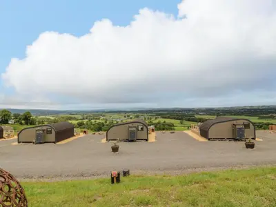 a group of three domes on a gravel field at Laird Lodge 3 in Lockerbie