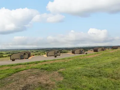 a group of three camels parked on a hill at Laird Lodge 3 in Lockerbie