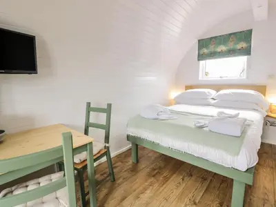 a bedroom with a bed and a desk and a television at Laird Lodge 5 in Lockerbie