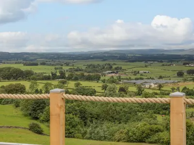 a view of the rolling hills from the porch of a house at Laird Lodge 5 in Lockerbie