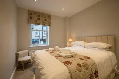 a bedroom with a large bed with towels on it at Waterfront Apartments in Douglas
