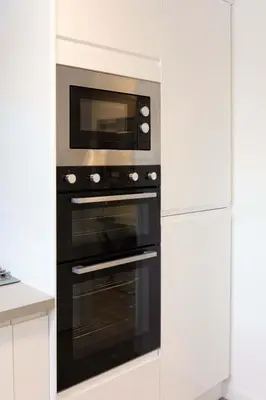a kitchen with a black oven with a microwave at 9A Millbrae - Donnini Apartments in Ayr