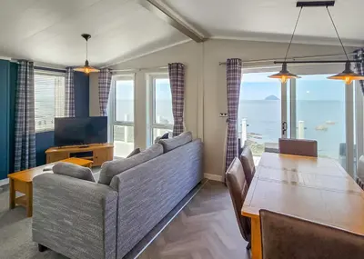 a living room with a couch and a table at Bennane Shore Holiday Park in Lendalfoot