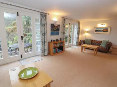 a living room with a couch and a table at Huntingstile Lodge in Ambleside