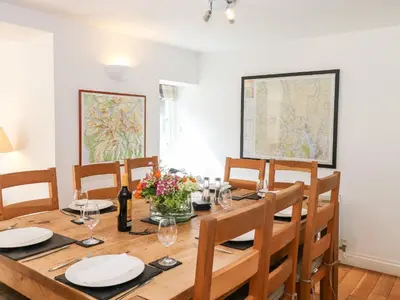 a dining room with a wooden table and chairs at Huntingstile Lodge in Ambleside