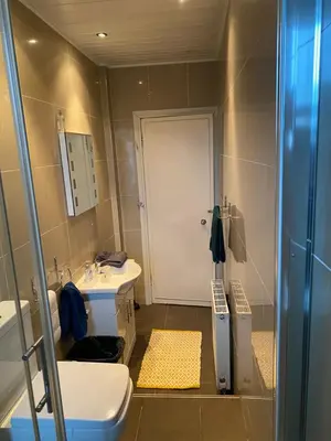 a bathroom with a sink and a toilet and a shower at Dalblair Apartment in Ayr