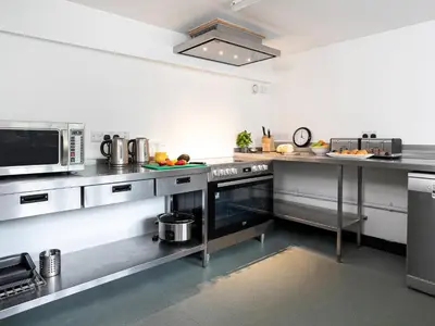 a large kitchen with stainless steel counters and appliances at Thorney How in Ambleside