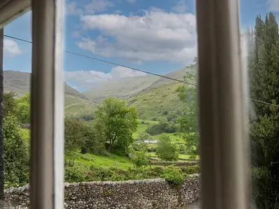 a view of a valley from a window at Thorney How in Ambleside