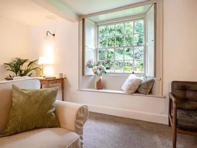 a living room with a couch and a window at Little How in Ambleside