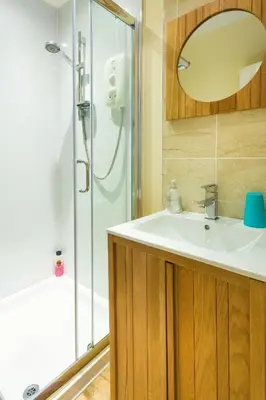 a bathroom with a sink and a shower at Neptunes Rest Guest Hotel in Stranraer