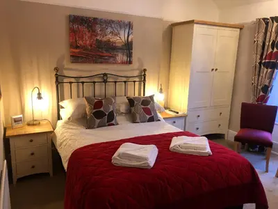 a bedroom with a bed with two towels on it at Tarn Hows in Keswick