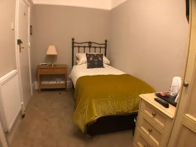 a small bedroom with a bed and a night stand at Tarn Hows in Keswick