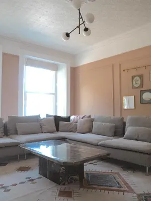 a living room with a couch and a coffee table at Coorie Away - Kirkcudbright in Kirkcudbright