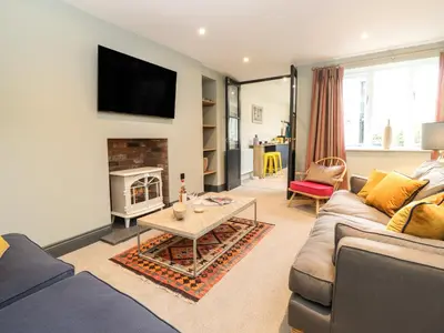 a living room with a couch and a fireplace at Fran's Nest in Keswick