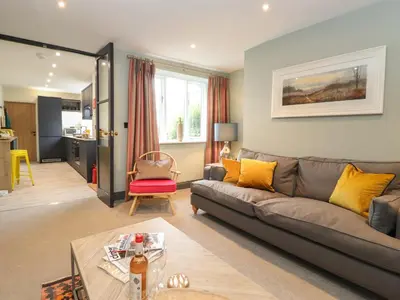 a living room with a couch and a table at Fran's Nest in Keswick