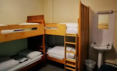 a room with three bunk beds and a sink at Elterwater Hostel in Elterwater