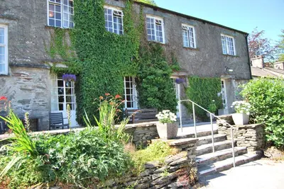an old stone building with ivy on it at Elterwater Hostel in Elterwater