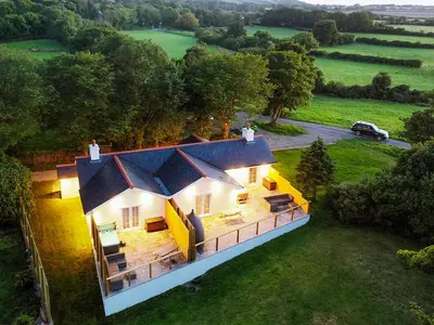 an aerial view of a house in a field at Bumblebee Cottage-Uk39918 in Ballakinnag
