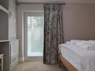 a bedroom with a bed and a window at 4 Harney Peak in Portinscale