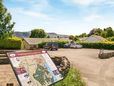 a sign in a parking lot with cars parked at 4 Harney Peak in Portinscale