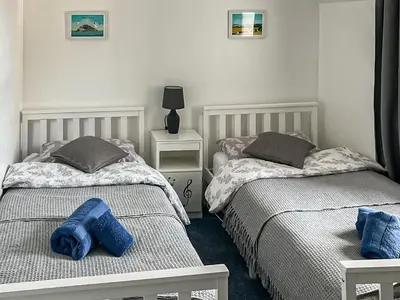 two beds sitting next to each other in a bedroom at Fiddlers Rest in Ballantrae