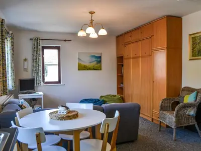a living room with a table and chairs at Buttermere Apartment in Keswick