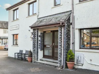 a building with a door and a bench in front of it at Buttermere Apartment in Keswick