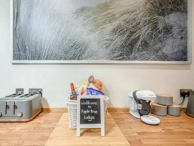a table with a chalkboard in front of a painting at Appletree Lodge in Ayr