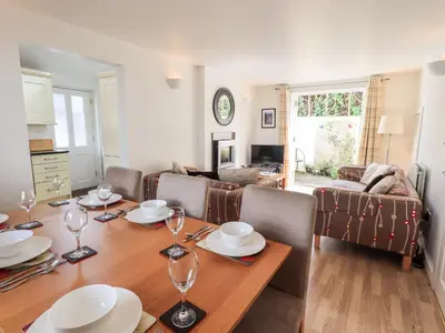 a dining room with a table and a living room at Fell Sweep in Keswick