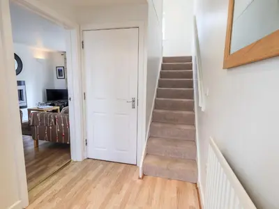 a staircase in a living room with a stair case at Fell Sweep in Keswick