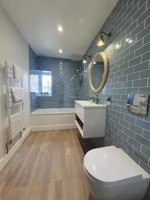 a bathroom with a toilet and a sink and a mirror at Grandy Nook in Keswick
