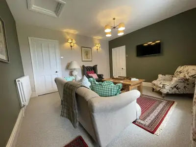 a living room with a couch and a table at Shelley Cottage in Keswick