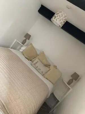 a bedroom with a bed with pillows on it at Cragside Cottage in Troutbeck