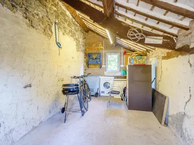 a kitchen with a refrigerator and a bicycle in a room at 1, The Barns in Threlkeld