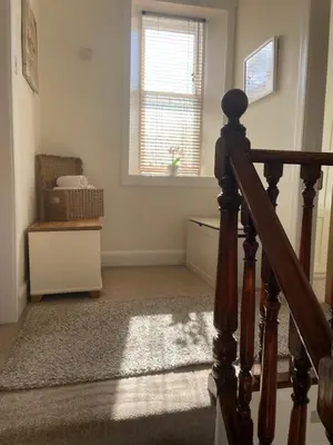 a room with a staircase and a window and a stair case at Character cottage in centre of Moffat in Moffat